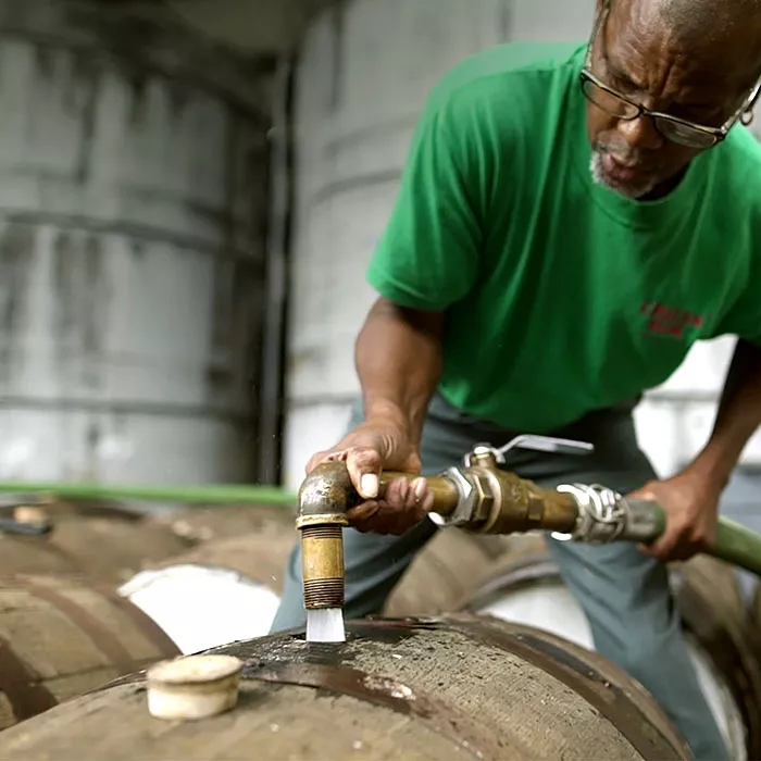 Cruzan employee fills oak barrels with what will become Cruzan Rum.