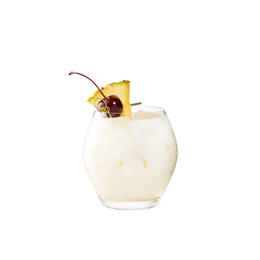 Cruzan® Piña Colada in a clear glass garnished with a cherry and pineapple.